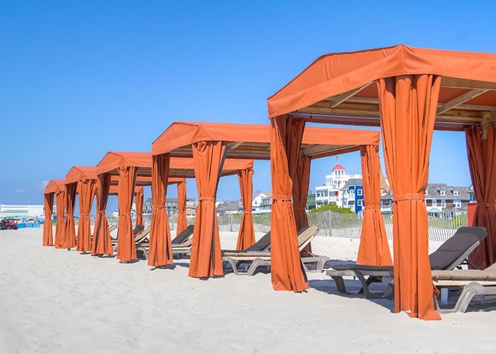 Cape May Beach Club's red cabanas on a clear blue day