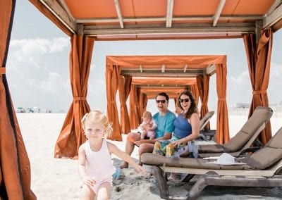 Happy family with kids inside beach cabana at Montreal Beach Resort
